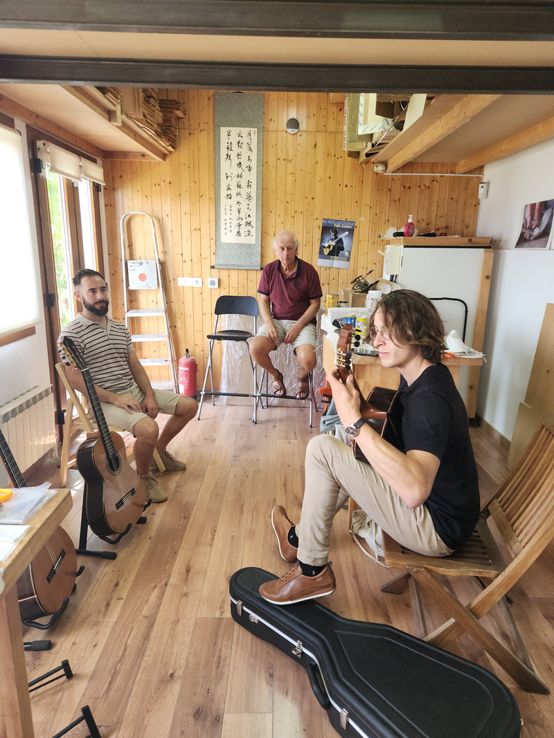 Three men in a room with musical instruments and equipment.